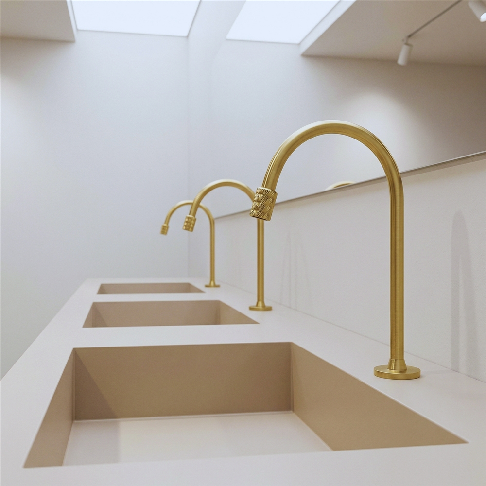 Brushed gold tall gooseneck basin faucet used as a warm metallic design reference